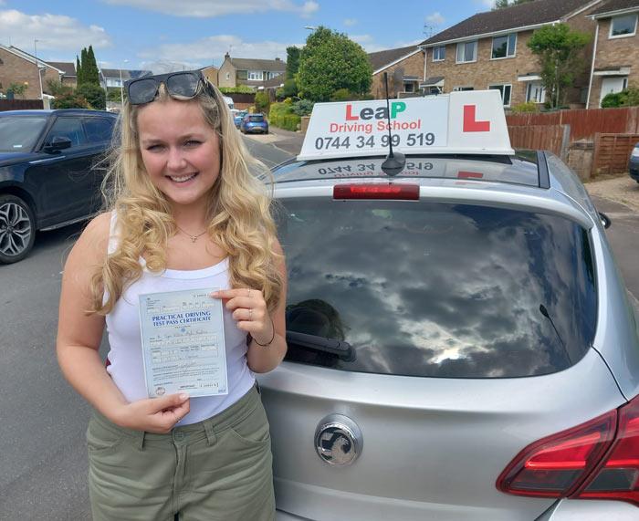 A pupil holding her driving licence pass certificate